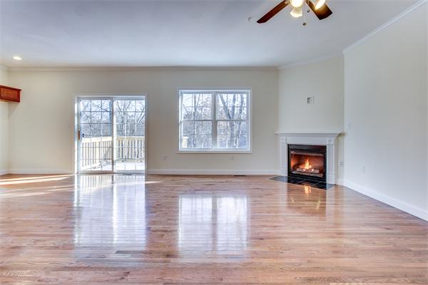 90 Rangeway Road, Unit 203 Billerica, MA 01862 - Photo 9 of 25 an empty room with wooden floor fireplace and windows