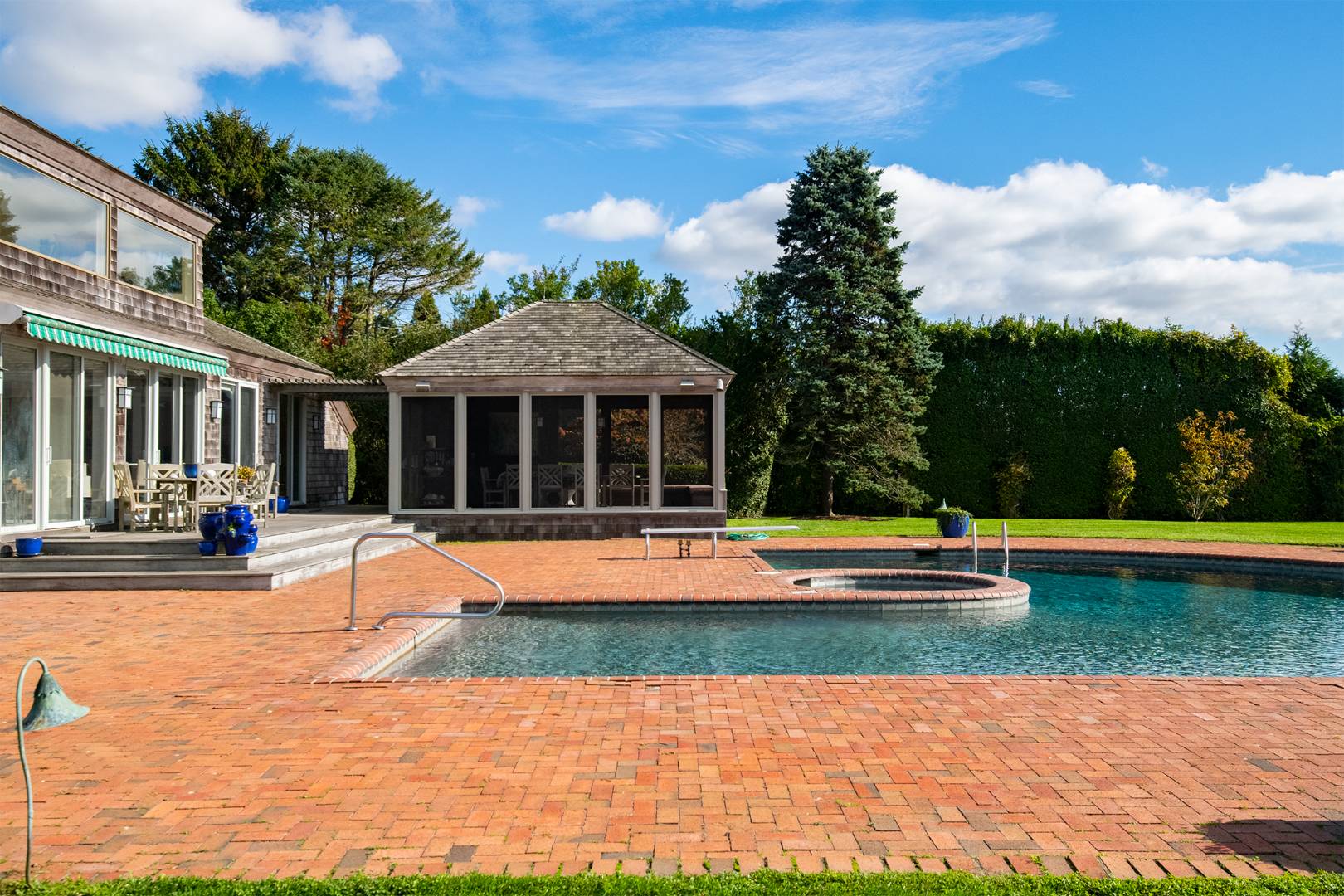 677 Mecox Road Water Mill, NY 11976 - Photo 13 of 24 a view of swimming pool with lawn chairs and plants