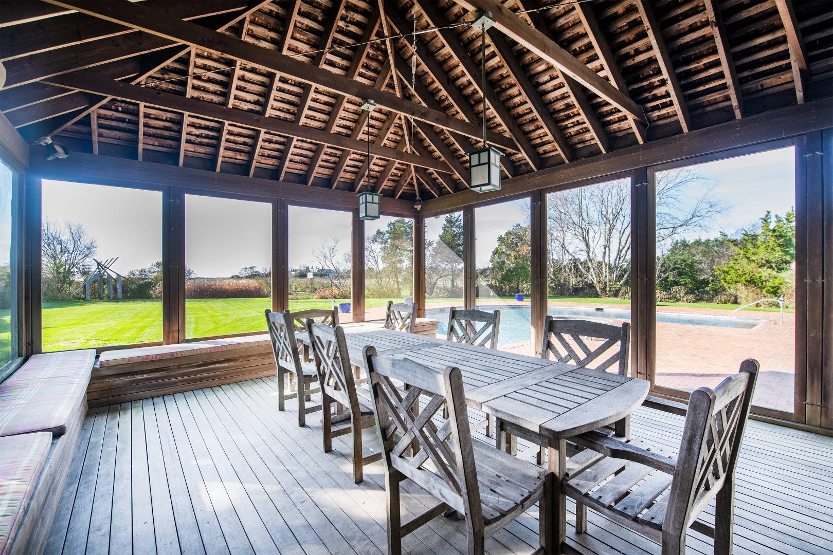 677 Mecox Road Water Mill, NY 11976 - Photo 16 of 24 a view of a patio with a table and chairs next to a yard