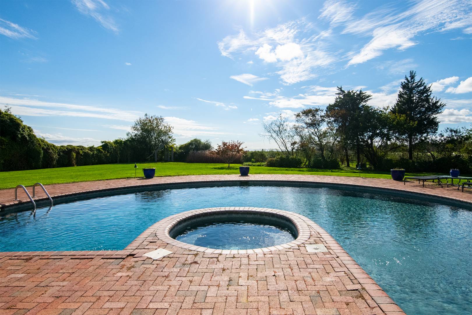 677 Mecox Road Water Mill, NY 11976 - Photo 6 of 24 a view of swimming pool that has lawn chairs with plants