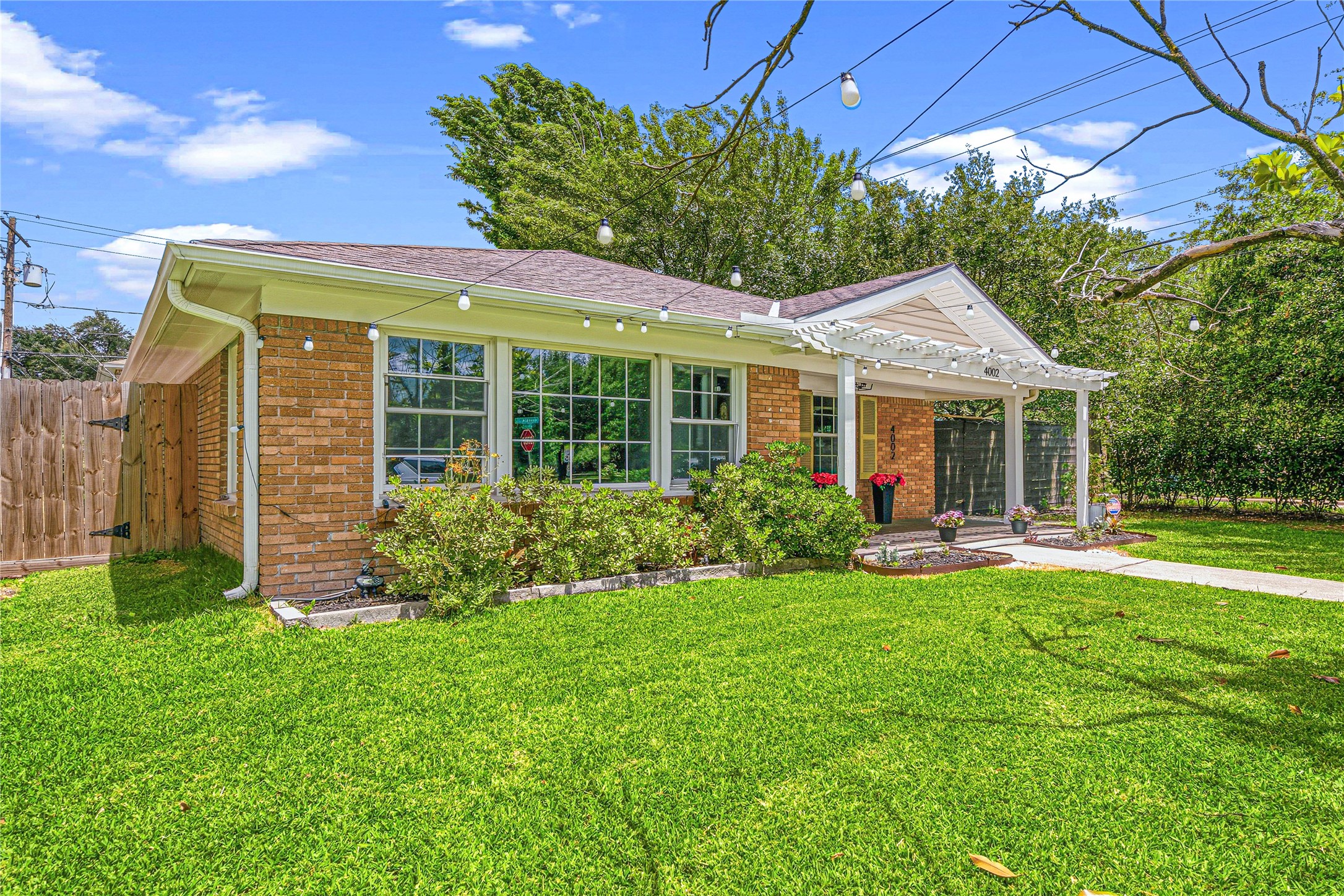 4002 Merrick Street Houston, TX 77025 - Photo 2 of 22 a front view of a house with garden and porch