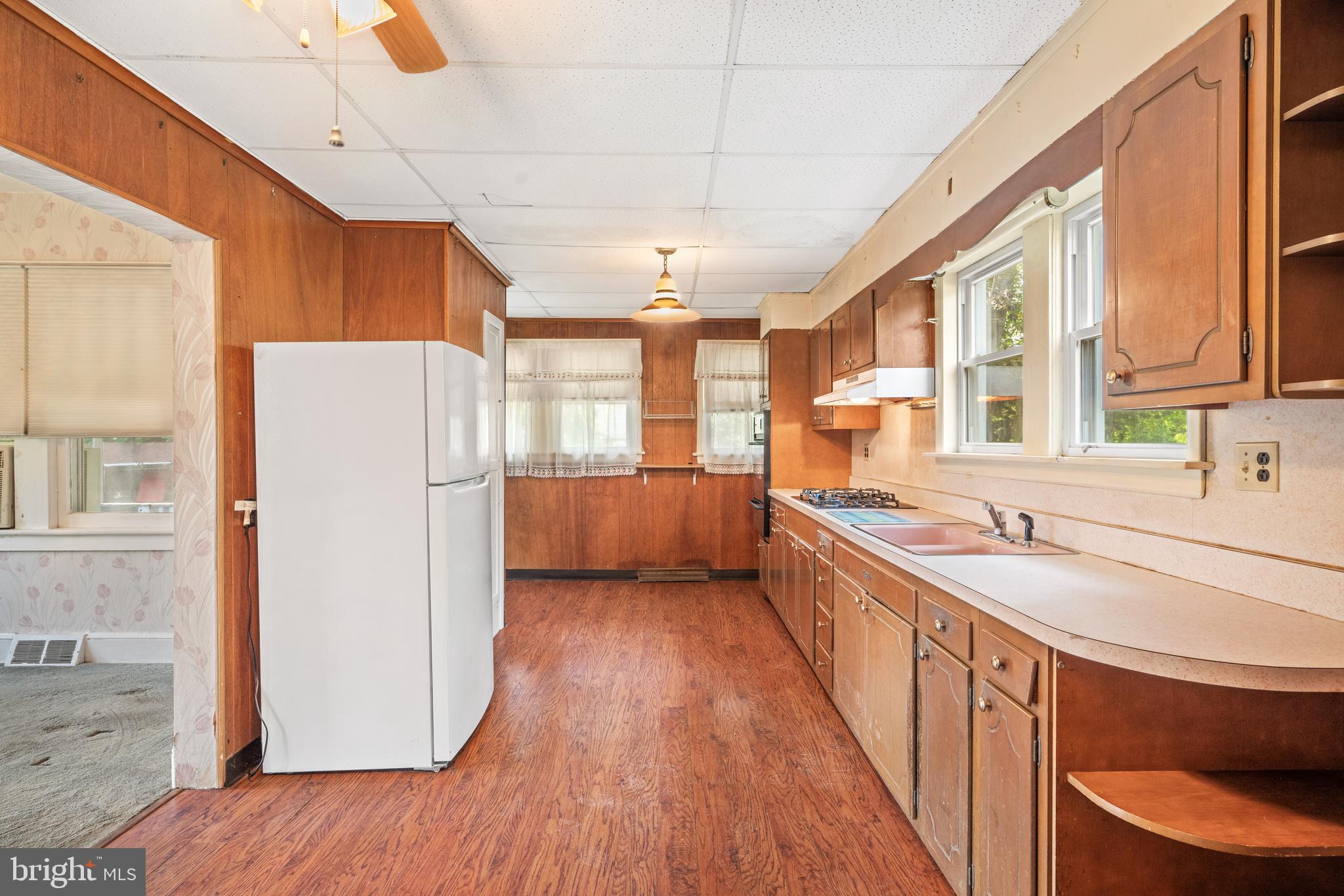 668 South Spring Road Vineland, NJ 08361 - Photo 16 of 24 a kitchen with a refrigerator a sink and dishwasher with wooden floor