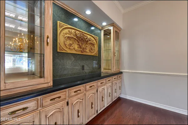 a kitchen with stainless steel appliances granite countertop a sink and cabinets with wooden floor