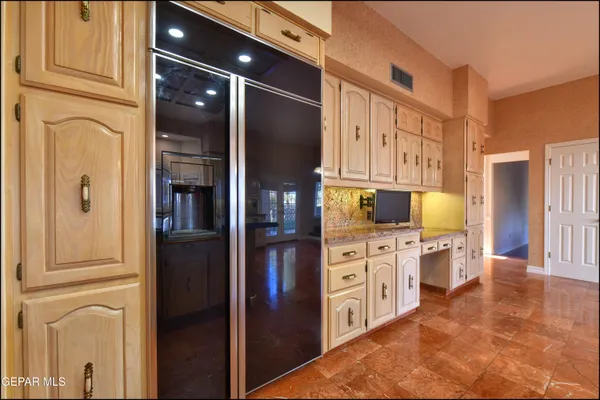 a kitchen with stainless steel appliances granite countertop a sink and cabinets with wooden floor