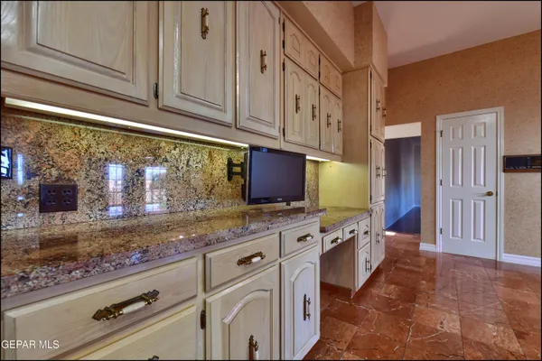 a kitchen with stainless steel appliances granite countertop a sink refrigerator and cabinets