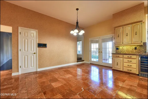 a view of an empty room with a fireplace and a window