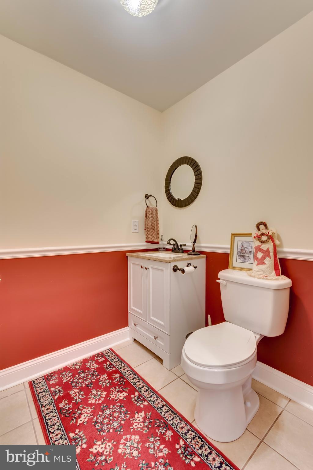 130 Raft Court Inwood, WV 25428 - Photo 10 of 24 a bathroom with a toilet a sink and a mirror