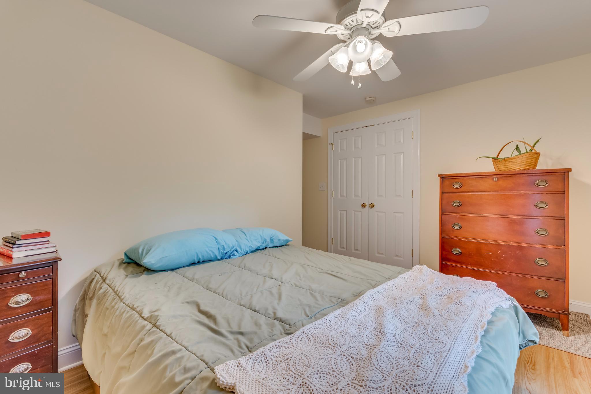 130 Raft Court Inwood, WV 25428 - Photo 19 of 24 a bedroom with a bed and a chandelier