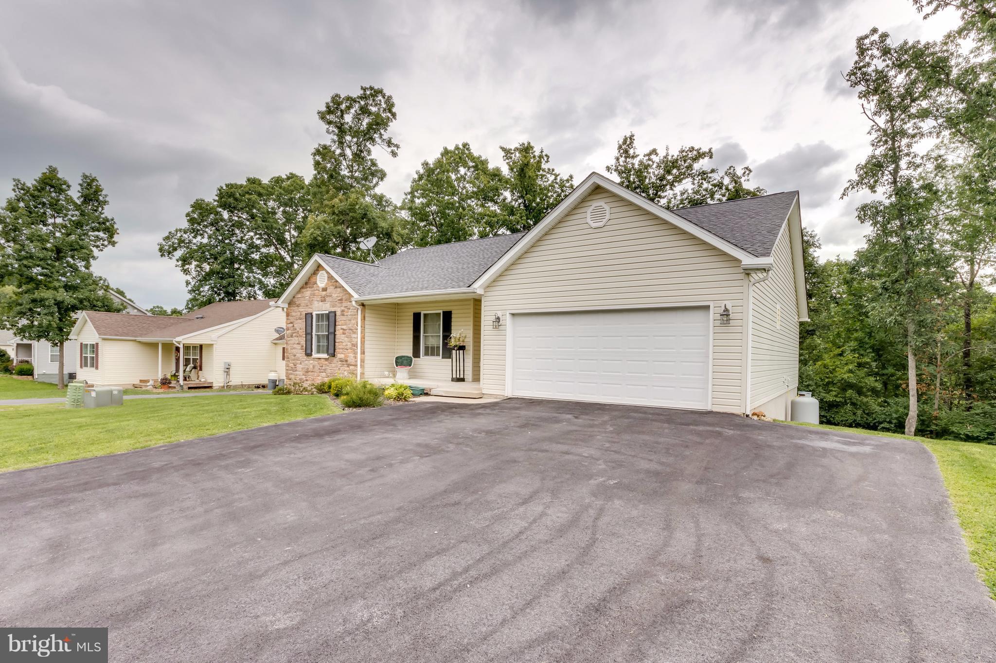 130 Raft Court Inwood, WV 25428 - Photo 22 of 24 a view of a house with a yard and large trees