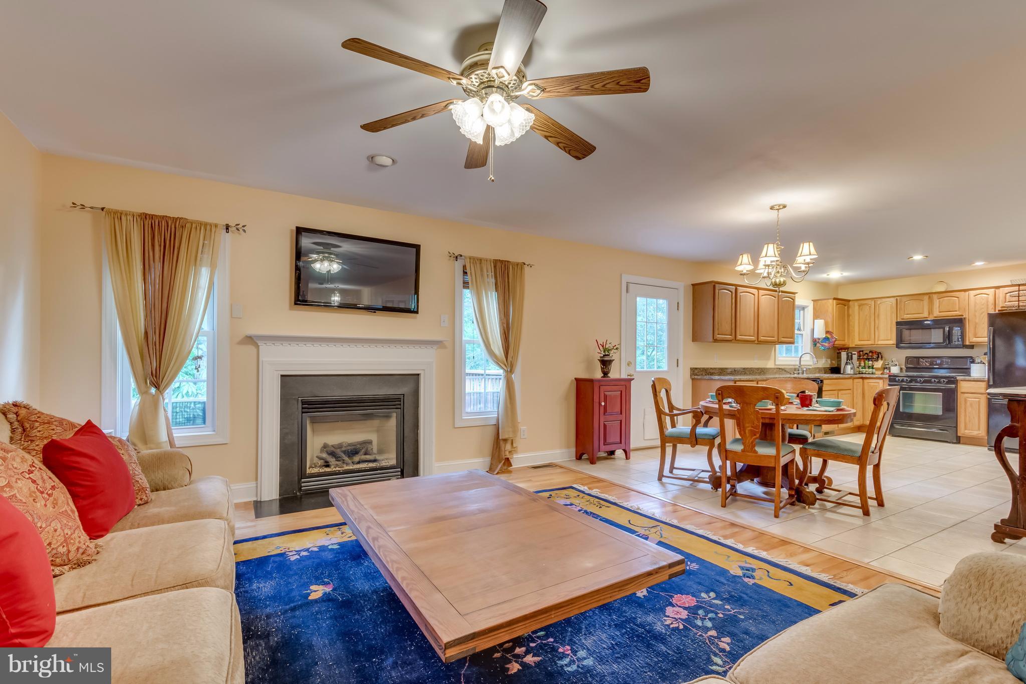 130 Raft Court Inwood, WV 25428 - Photo 5 of 24 a living room with furniture a flat screen tv and a fireplace