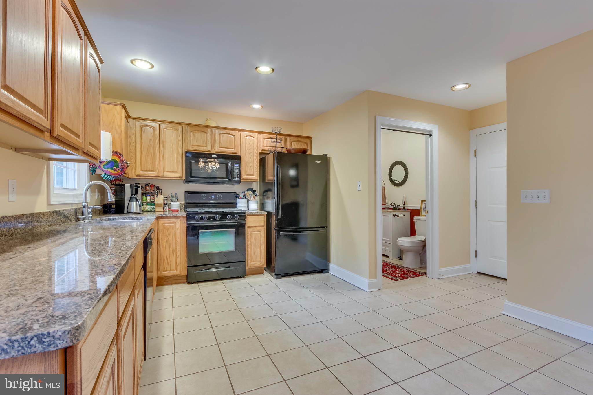 130 Raft Court Inwood, WV 25428 - Photo 9 of 24 a kitchen with stainless steel appliances granite countertop a refrigerator and a sink