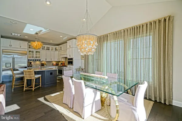a living room with furniture a fireplace and a floor to ceiling window
