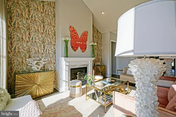a view of a hallway with wooden floor and a bathroom