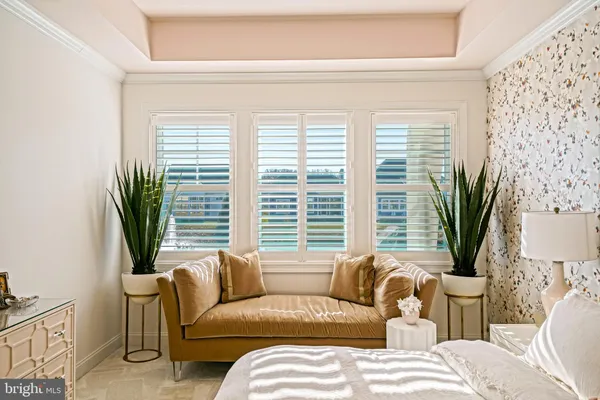 a living room with furniture a wooden floor and a large window