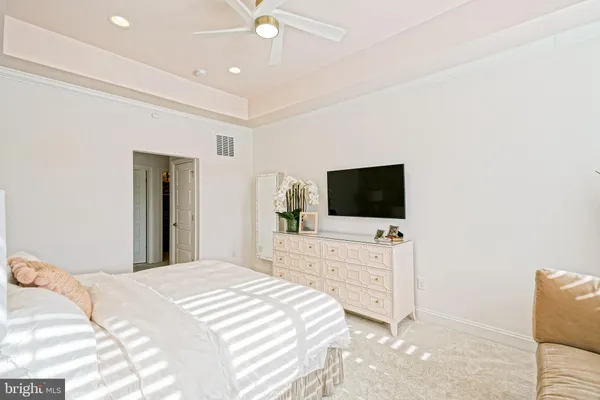 a living room with furniture a flat screen tv and a floor to ceiling window