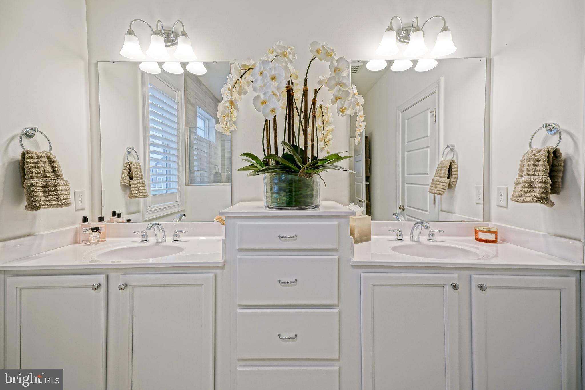11078 Marvil Road Lewes, DE 19958 - Photo 30 of 98 a bathroom with a double vanity sink and a mirror