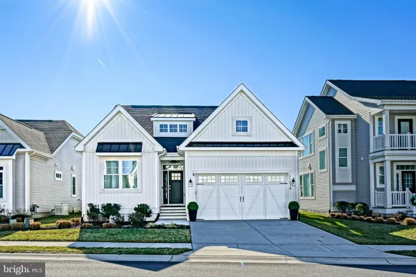 a kitchen with stainless steel appliances granite countertop white cabinets and a stove