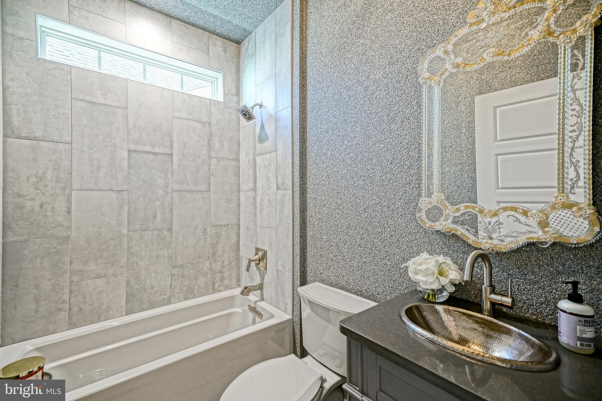 11078 Marvil Road Lewes, DE 19958 - Photo 40 of 98 a bathroom with a sink toilet a mirror and shower