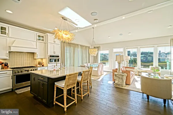 a kitchen that has a lot of cabinets in it and wooden floors