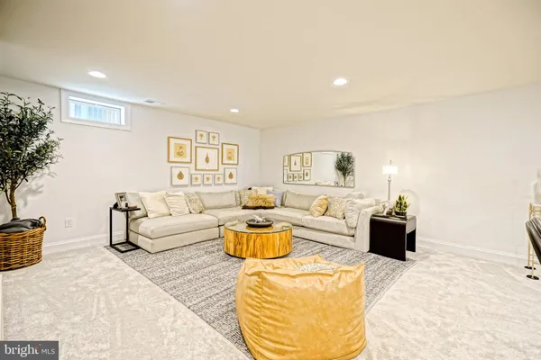 a view of a patio with a table and chairs under an umbrella with a small yard