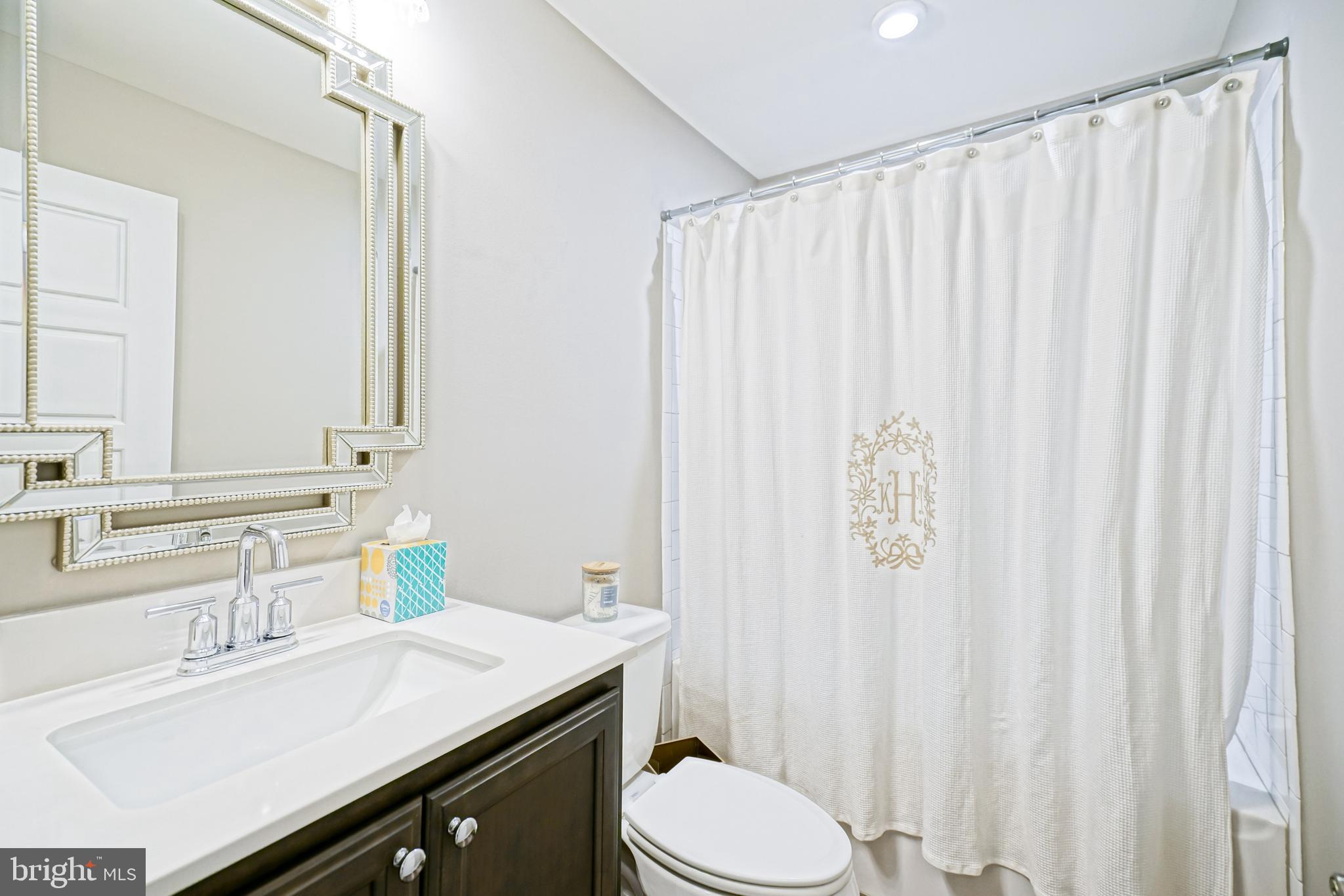 11078 Marvil Road Lewes, DE 19958 - Photo 71 of 98 a bathroom with a sink a toilet and shower curtain