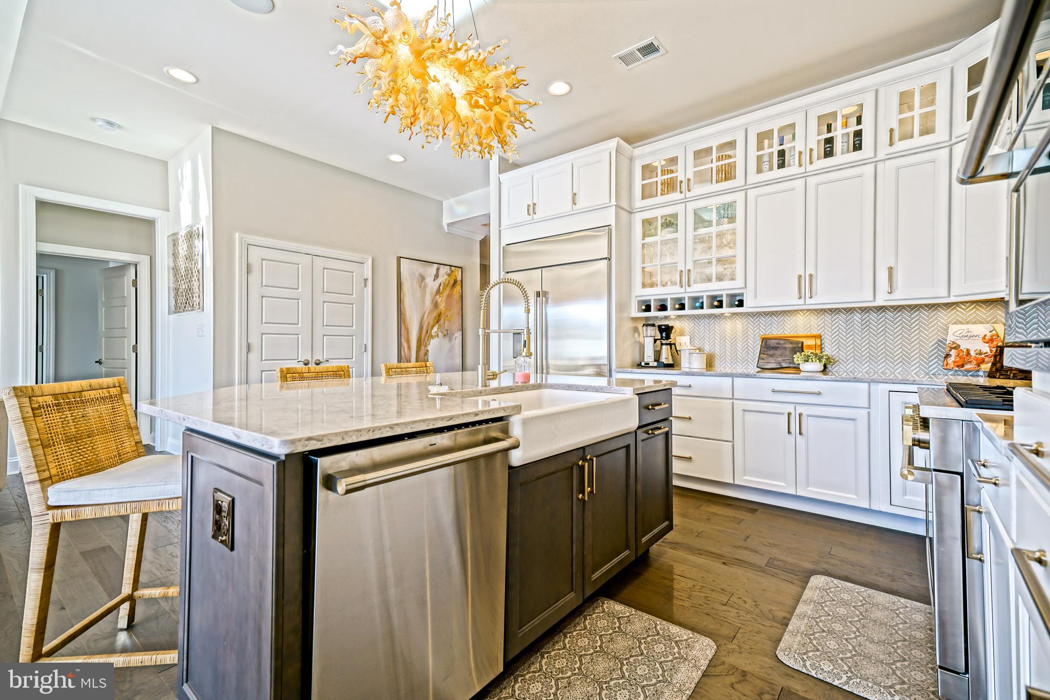 11078 Marvil Road Lewes, DE 19958 - Photo 10 of 98 a kitchen that has a lot of cabinets in it and wooden floors