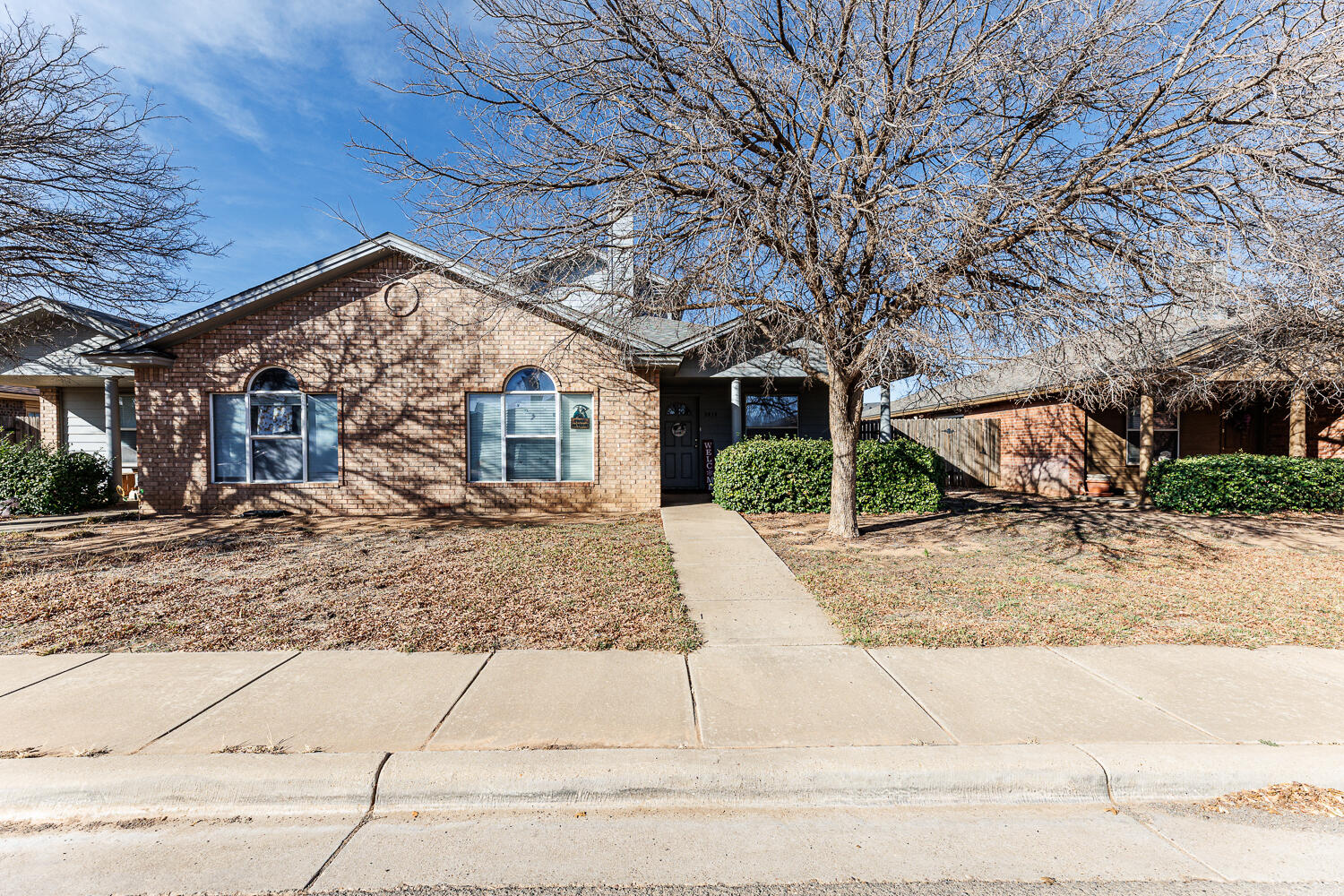 3414 97th Street Lubbock, TX 79423 - Photo 1 of 8 front view of a house with a street