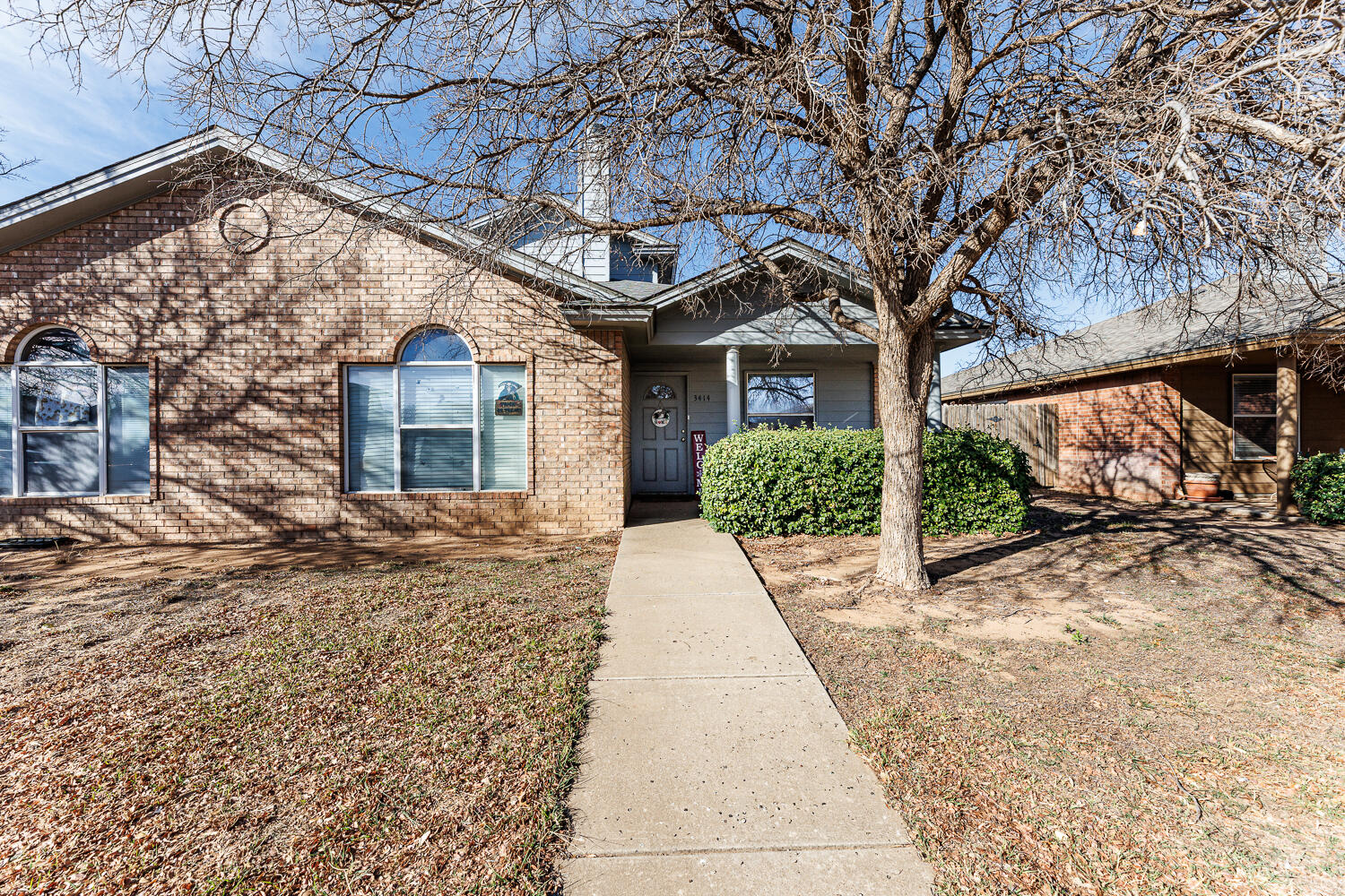 3414 97th Street Lubbock, TX 79423 - Photo 2 of 8 a front view of a house with a yard