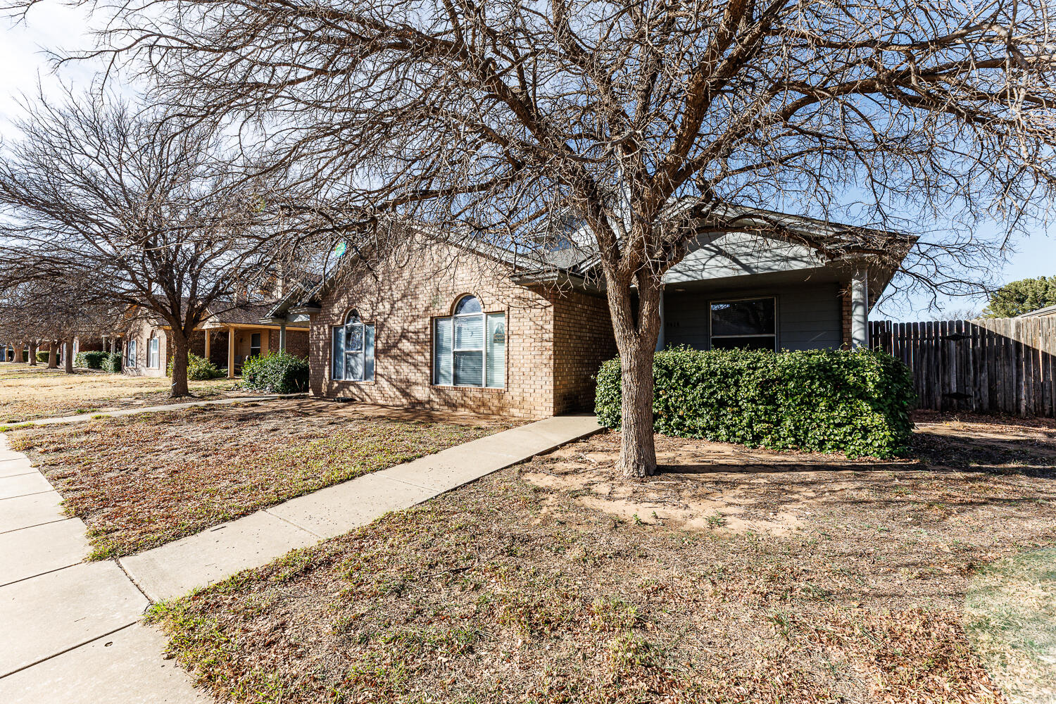 3414 97th Street Lubbock, TX 79423 - Photo 3 of 8 a front view of a house with a yard and garage