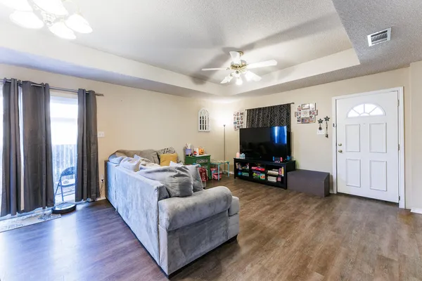 a living room with furniture and a flat screen tv