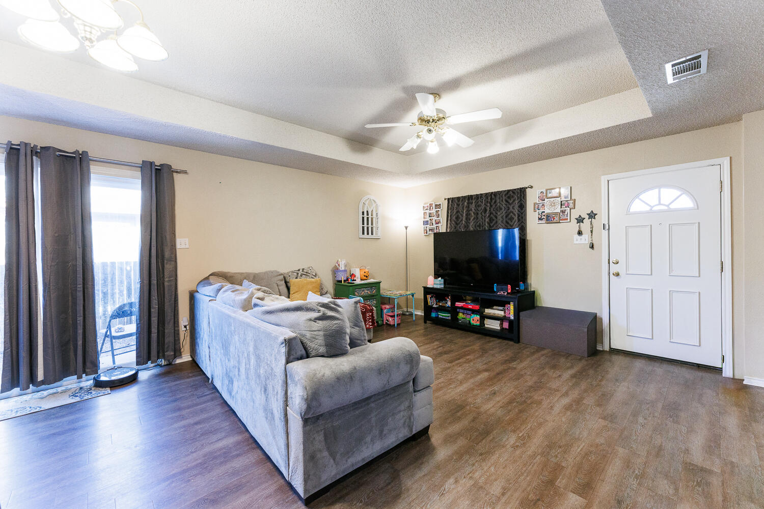 3414 97th Street Lubbock, TX 79423 - Photo 5 of 8 a living room with furniture and a flat screen tv