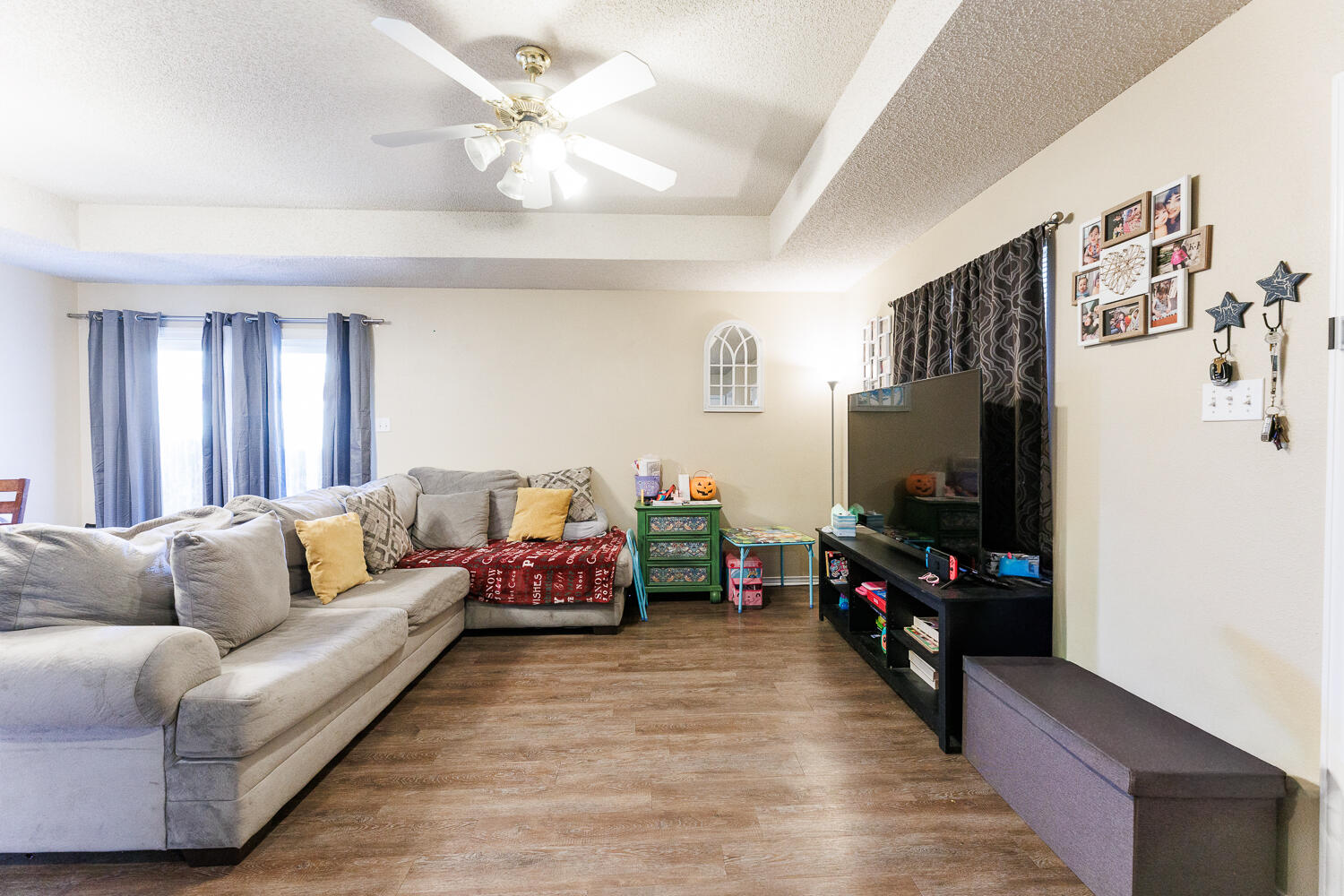 3414 97th Street Lubbock, TX 79423 - Photo 6 of 8 a living room with furniture and a flat screen tv