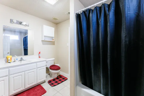 a bathroom with a sink vanity and mirror