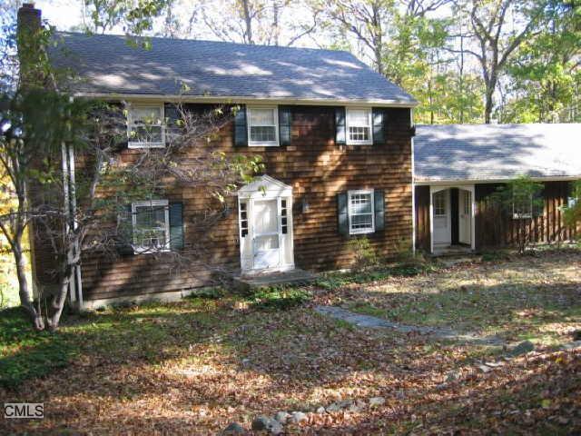112 Standish Drive Ridgefield, CT 06877 - Photo 1 of 1 a front view of a house with garden