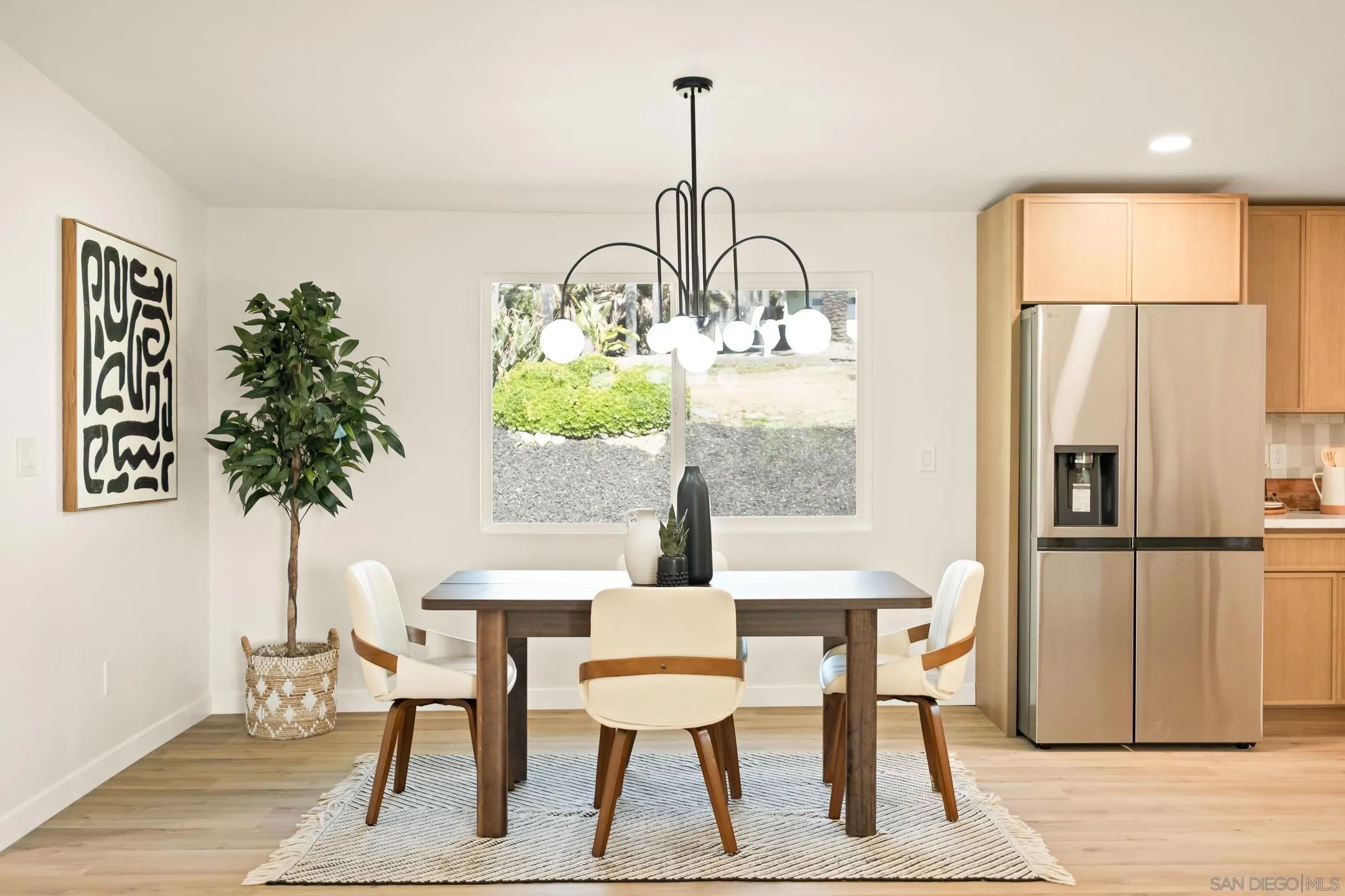 557 Sunset Drive Vista, CA 92081 - Photo 12 of 36 a view of a dining room with furniture window and wooden floor