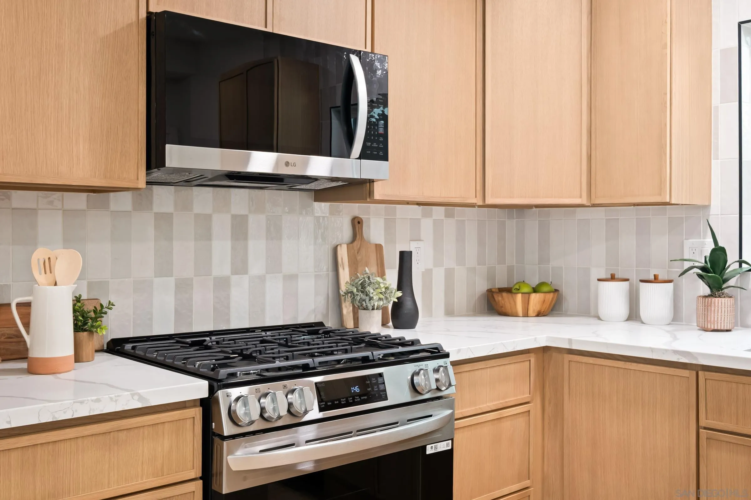 557 Sunset Drive Vista, CA 92081 - Photo 15 of 36 a kitchen with granite countertop cabinets and stainless steel appliances