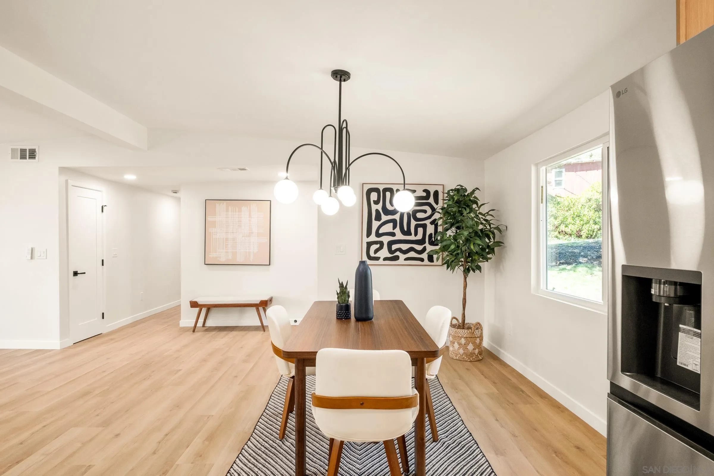 557 Sunset Drive Vista, CA 92081 - Photo 16 of 36 a living room with furniture a window and a flat screen tv