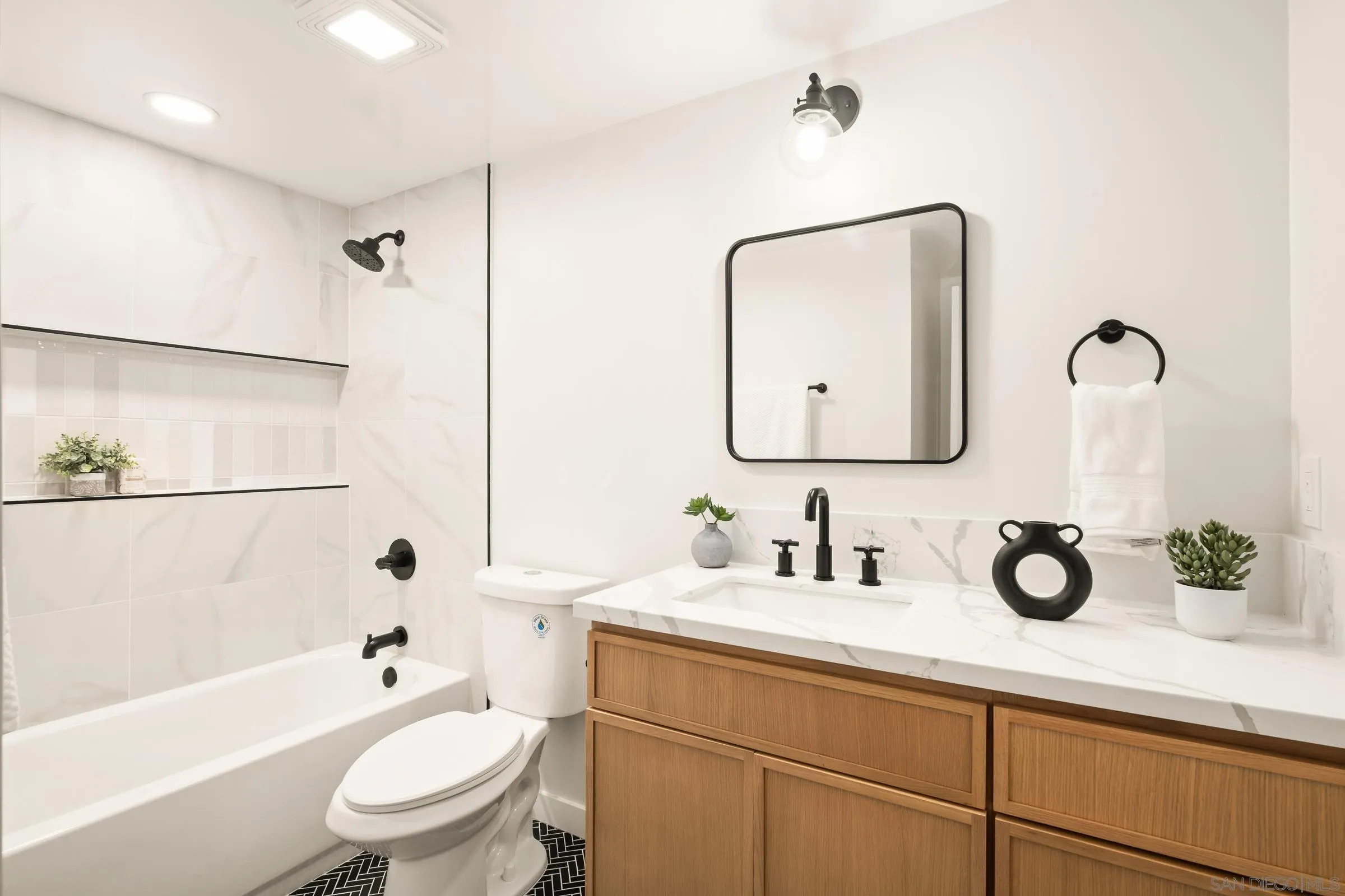 557 Sunset Drive Vista, CA 92081 - Photo 17 of 36 a bathroom with a double vanity sink toilet mirror and shower