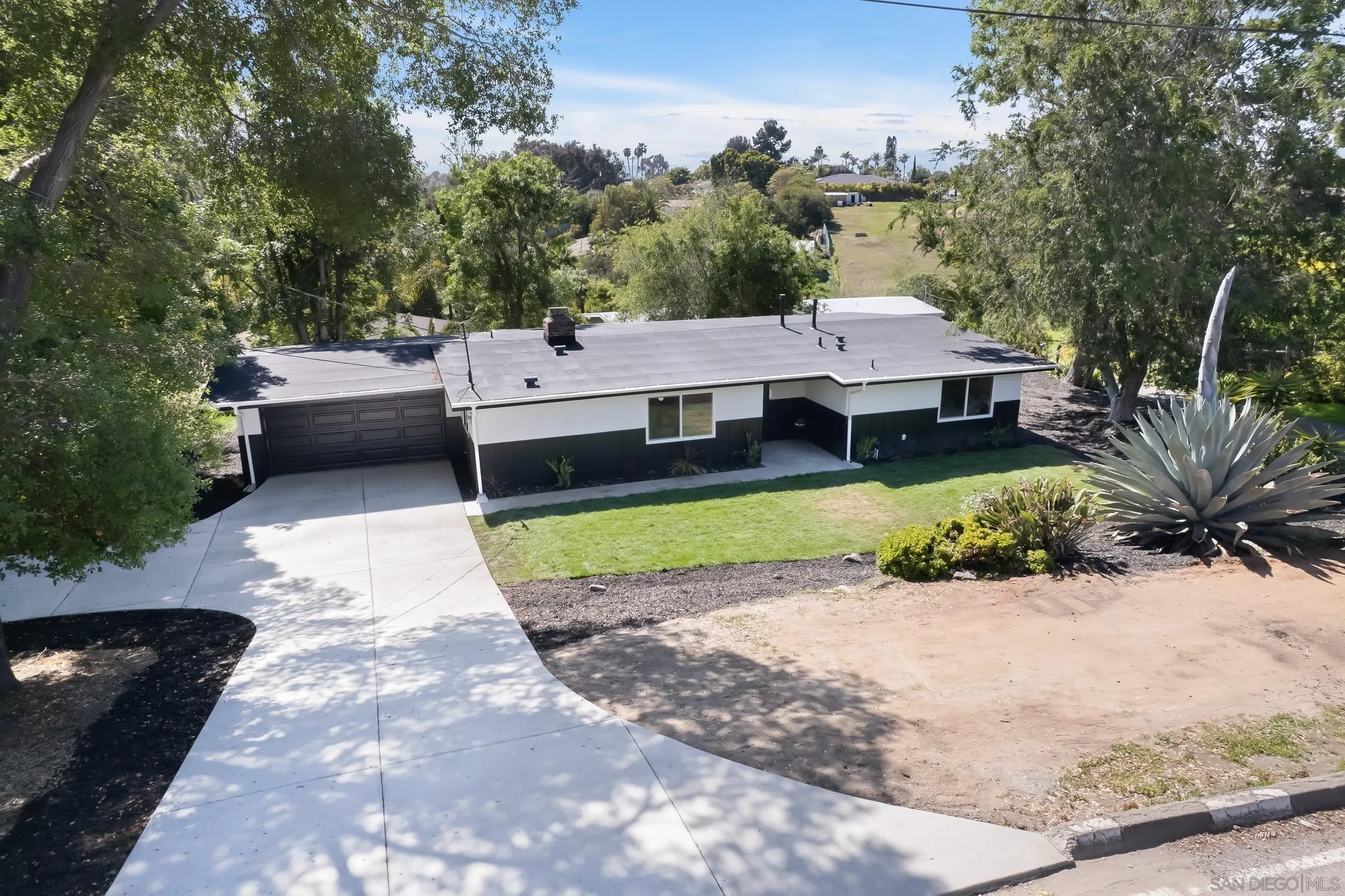 557 Sunset Drive Vista, CA 92081 - Photo 2 of 36 a view of a patio with a table and chairs under an umbrella