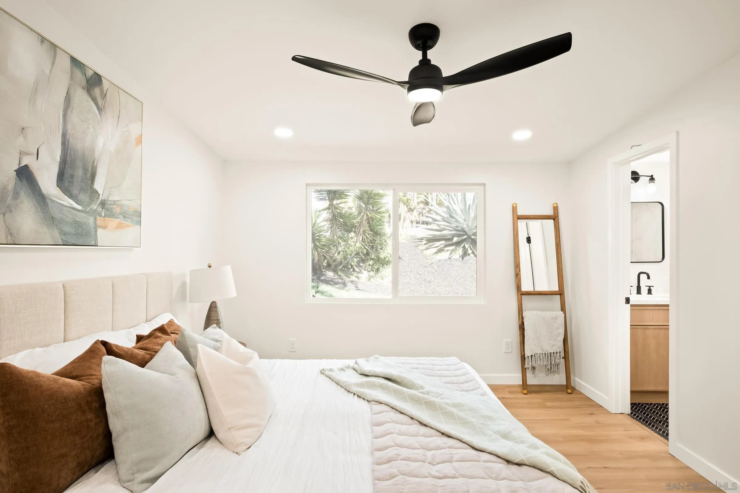 557 Sunset Drive Vista, CA 92081 - Photo 24 of 36 a bedroom with a large bed and a window