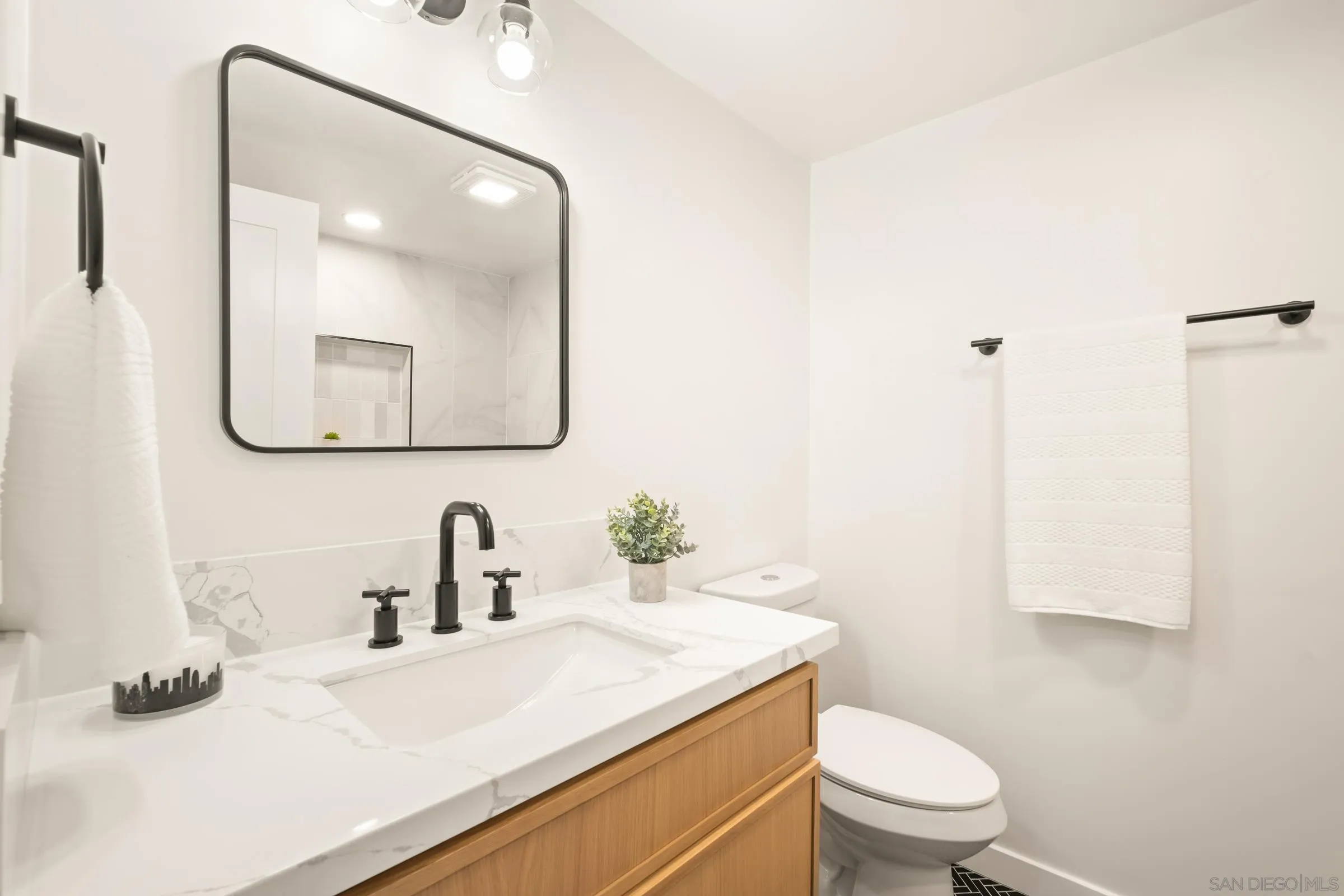 557 Sunset Drive Vista, CA 92081 - Photo 26 of 36 a bathroom with a toilet sink and mirror
