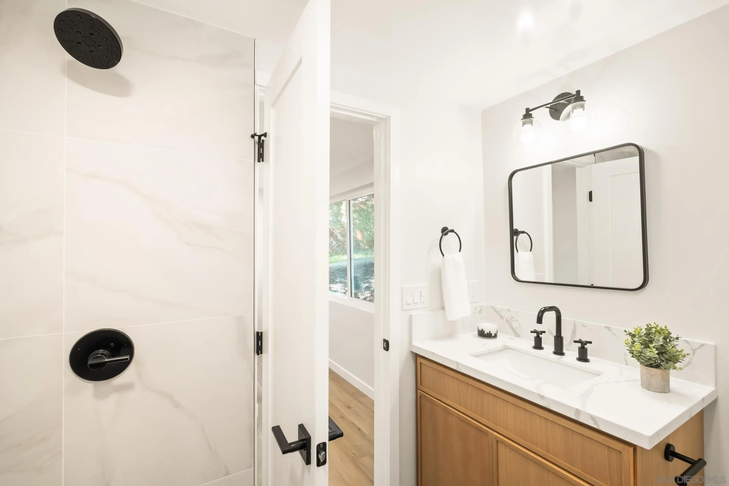 557 Sunset Drive Vista, CA 92081 - Photo 27 of 36 a bathroom with a granite countertop sink mirror and vanity