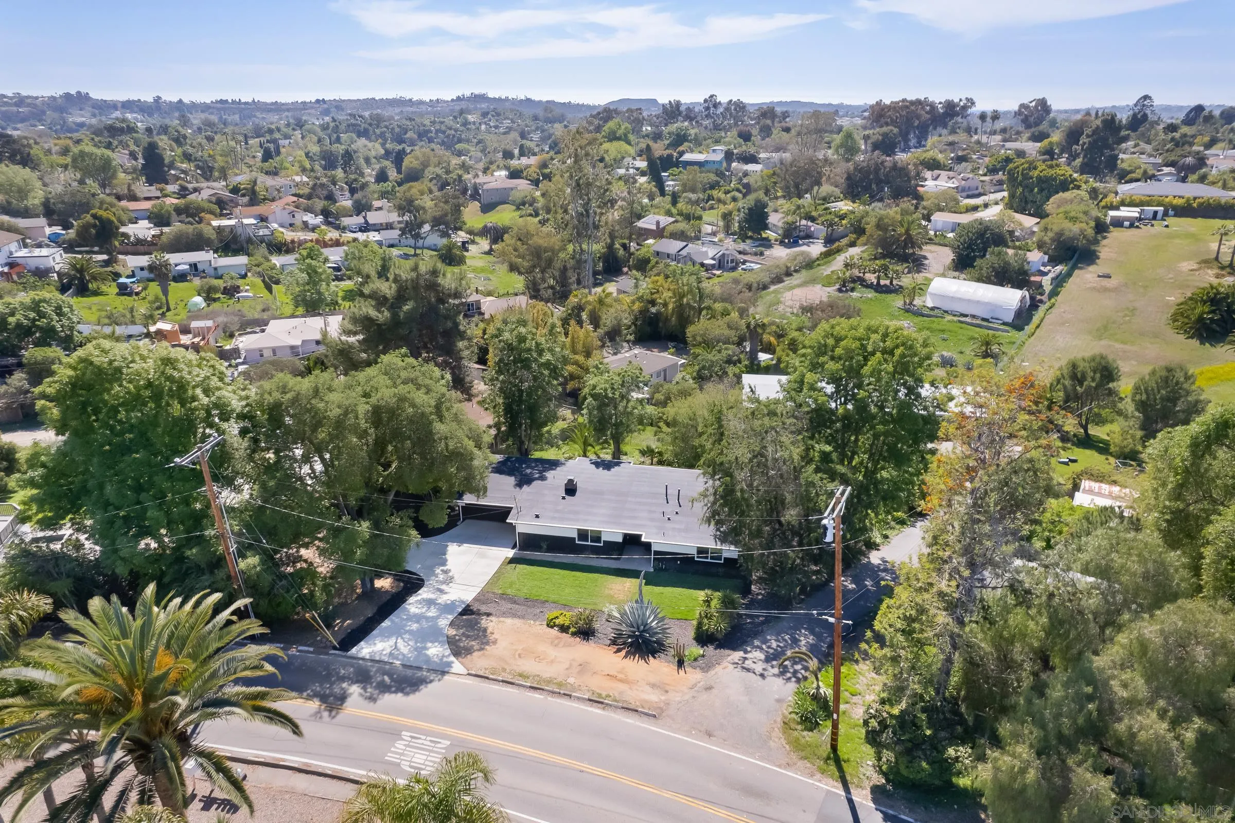 557 Sunset Drive Vista, CA 92081 - Photo 36 of 36 an aerial view of a house with a yard and lake view