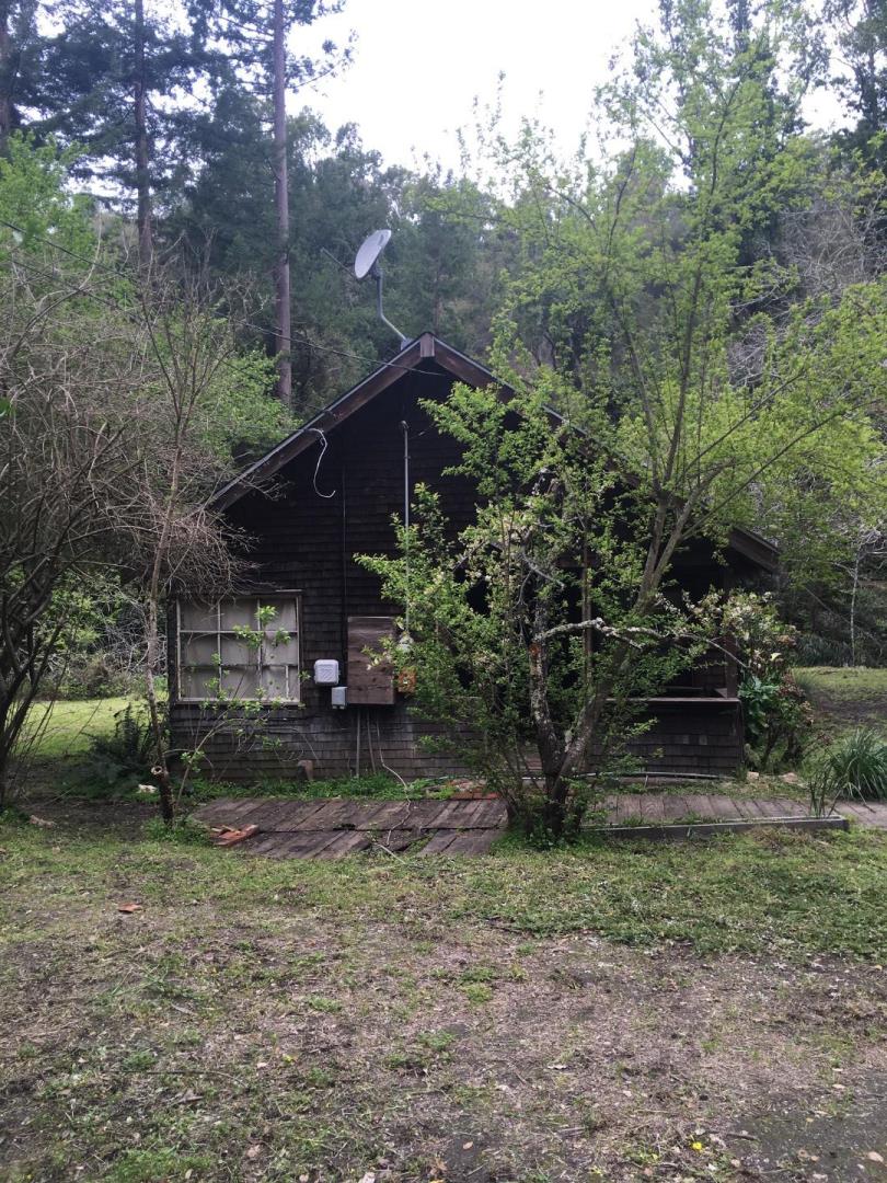990 North Rodeo Gulch Road Soquel, CA 95073 - Photo 2 of 8 a view of a wooden house with a yard