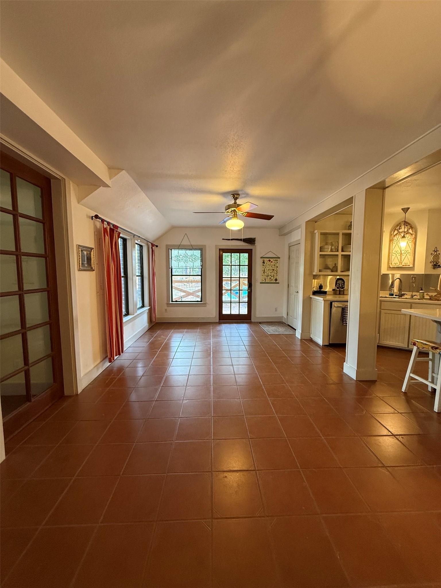 363 Porter Road Bastrop, TX 78602 - Photo 13 of 37 Rich tile flooring anchors this versatile space flanked by glass doors and warm woodwork.