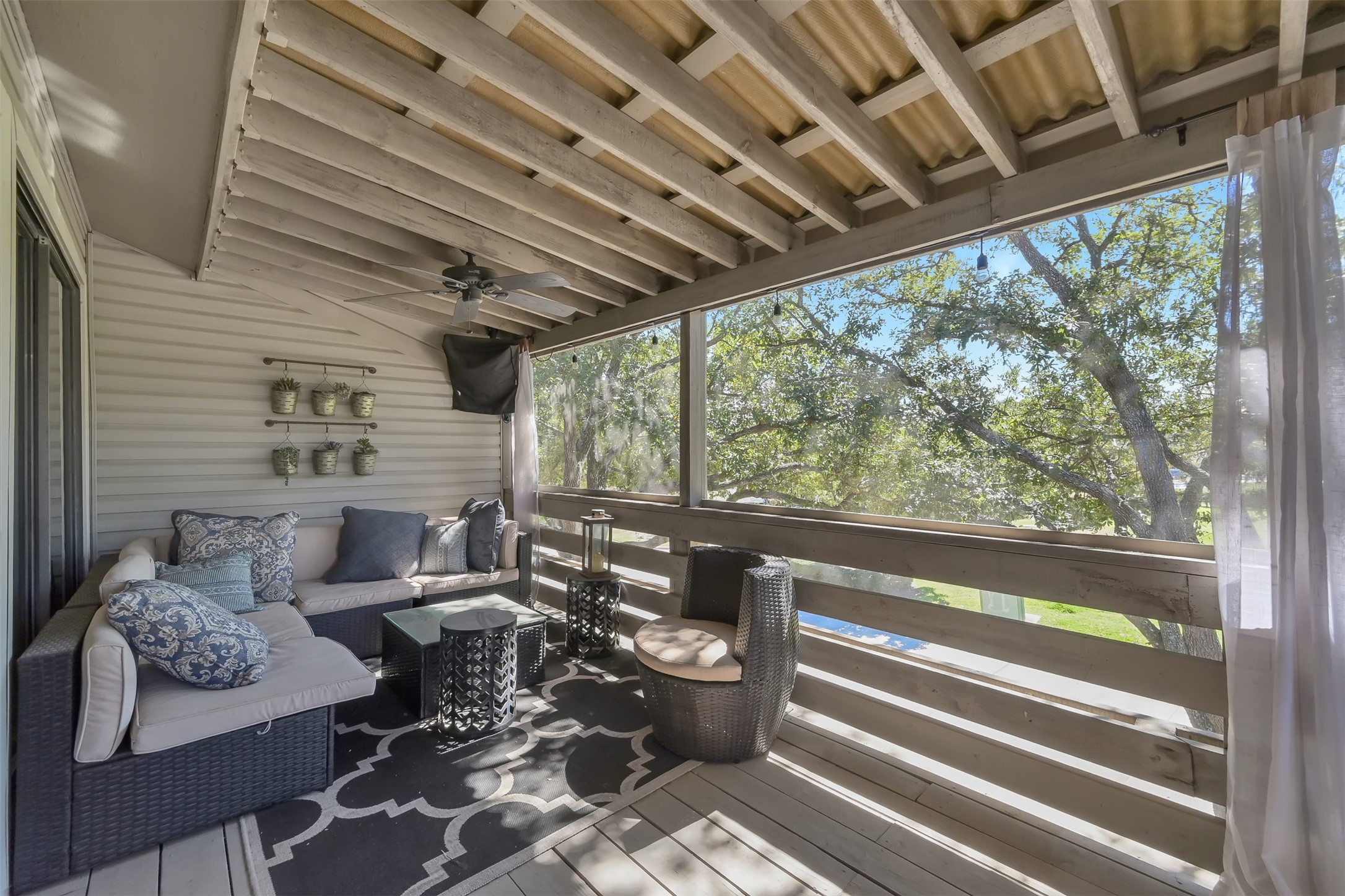 184 April Point Drive North Conroe, TX 77356 - Photo 32 of 41 Between the screens, the curtains, the fan and the large shade tree, you may never want to go back inside!