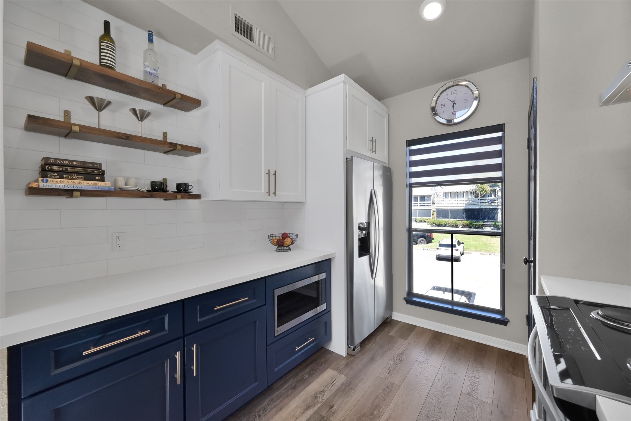 184 April Point Drive North Conroe, TX 77356 - Photo 8 of 41 On this side of the kitchen you see the recently updated refrigerator and microwave, coffee bar with floating shelves