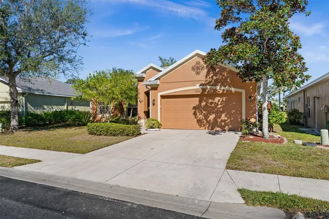 a front view of a house with a yard and trees