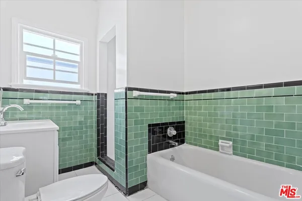 a bathroom with a sink a toilet and tub