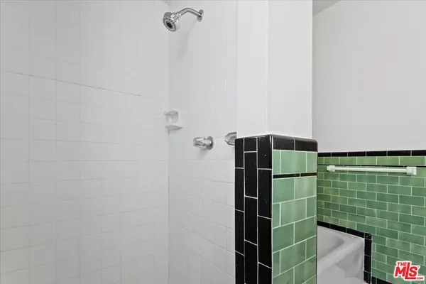 a bathroom with a shower and a sink